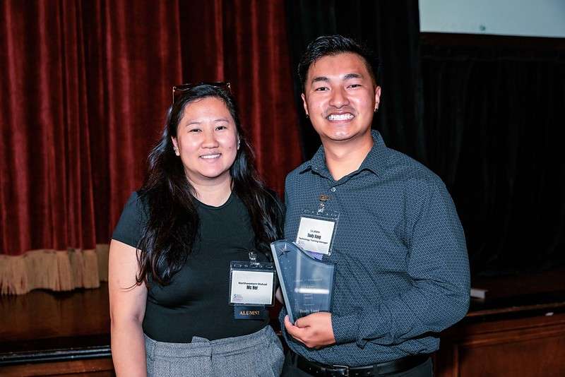 a woman and a man holding an award